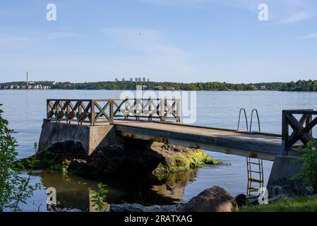 Sommermorgen am See. Hölzerne Anlegestelle mit Blick auf einen herrlichen See in der Wildnis. Altes Holzdock. Stockfoto