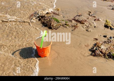 Plastikeimer am Strand vergessen Stockfoto