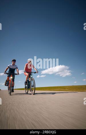 Ein Paar, Mann und Frau, die mit Fahrrädern, Trekkingrad, Stockfoto