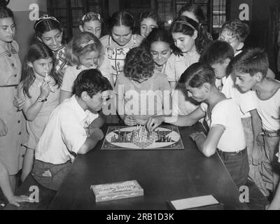 New York, New York: c. 1933 Kinder am Urlaubsspielplatz 189 Brooklyn spielen das Brettspiel Khing Cong. Stockfoto