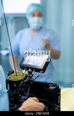 Kameramann, der eine Krankenhausserie mit Krankenschwester im Hintergrund dreht Stockfoto