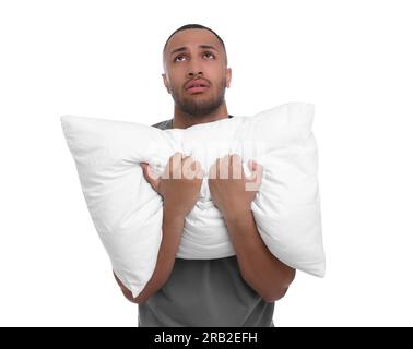 Müder Mann mit Kissen auf weißem Hintergrund. Schlaflosigkeit-Problem Stockfoto