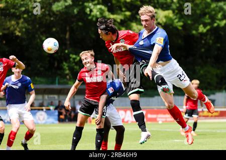 Kiel, Deutschland. 07. Juli 2023. Fußball: Testspiele, Holstein Kiel - Hannover 96. Hannovers Sei Muroya (M) und Kieles Lasse Rosenboom kämpfen um den Ball. Kredit: Frank Molter/dpa/Alamy Live News Stockfoto