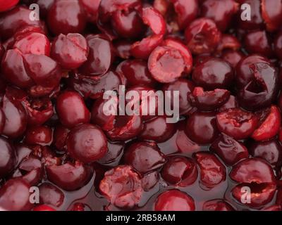 Ein Haufen entsteinter roter Kirschen in Kirschsaft. Schließen. Stockfoto