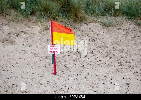 Rote und gelbe Rettungsschwimmerfahne, Ende der Strandpatrouille Stockfoto