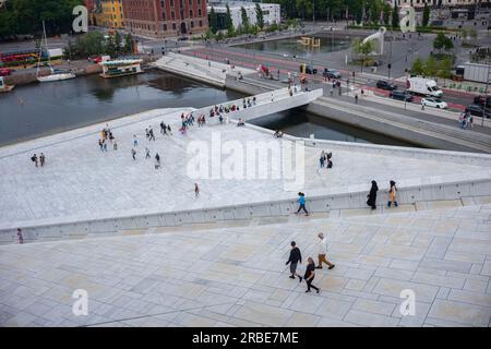 Oslo, Norwegen, 19. Juni 2023: Touristen erkunden das Opernhaus von Oslo an einem bewölkten Tag, das 2008 mit der Absicht erbaut wurde, Besucher nach wa zu lassen Stockfoto