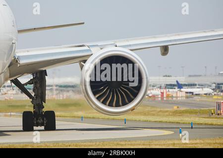 Heiße Luft hinter dem Triebwerk des Flugzeugs am Flughafen. Das Flugzeug fährt während des sonnigen Sommertags zur Startbahn. Stockfoto