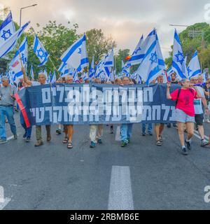 Haifa, Israel - 08. Juli 2023: Menschen marschieren mit Flaggen und verschiedenen Zeichen. Woche 27 des Protests gegen die Regierung in Haifa, Israel Stockfoto