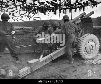 Frankreich: 18. Oktober 1944. Ein Team japanisch-amerikanischer G.I. feuert 105-mm-Granaten auf Deutsche ab, um einen Infanterieangriff irgendwo in Frankreich zu unterstützen. Stockfoto