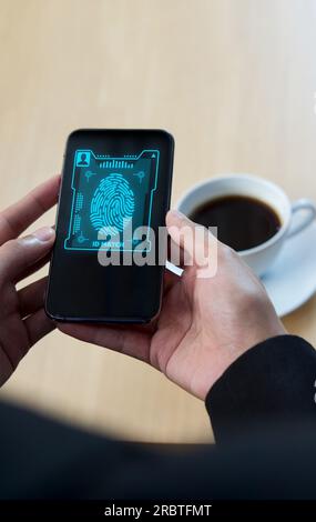 Futuristische digitale Verarbeitung des biometrischen Identifikations-Fingerabdruckscanners auf dem Smartphone. Überwachungs- und Sicherheitsscans digitaler Programme Stockfoto