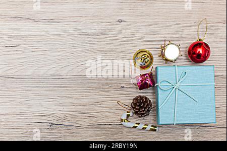 Weihnachtliche Geschenkboxen mit Blick aus dem hohen Winkel auf rustikalem Holzfußboden. Die Geschenke sind an den Rändern des Rahmens verstreut, sodass etwas Platz bleibt Stockfoto