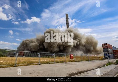 Kiel, Deutschland. 11. Juli 2023. Während der Explosion des ehemaligen Kesselhauses auf dem Gelände des Kraftwerks Kiel steigt eine Rauch- und Staubwolke in den Himmel. Nach zwei Explosionsversuchen wurde das Gebäude nicht vollständig zerstört. Kredit: Axel Heimken/dpa/Alamy Live News Stockfoto