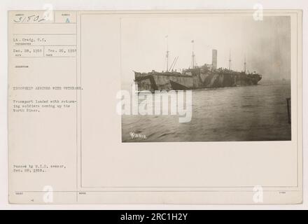 Eine Gruppe von Soldaten, die auf einem Truppenschiff nach Hause zurückkehren, vom Deck eines anderen Schiffes aus gesehen. Das Truppenschiff ist beladen mit wiederkehrenden Veteranen und reist den North River hinauf. Dieses Foto wurde am 26. Dezember 1918 aufgenommen und wurde am 28. Dezember 1918 durch eine Militärzensur gebracht. Stockfoto