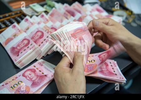 HAIAN, CHINA - 12. JULI 2023 - Ein Bankangestellter zählt chinesischen Yuan in Haian, Ostchina Provinz Jiangsu, 12. Juli 2023. Die chinesische Volksbank Stockfoto