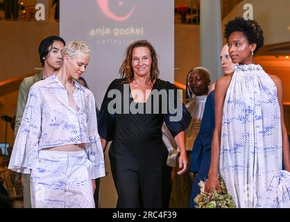 Berlin, Deutschland. 12. Juli 2023. Die Designerin Anja Gockel (M) steht mit ihren Models auf dem Laufsteg nach ihrer Show während der Berliner Modewoche im Hotel Adlon. Kredit: Jens Kalaene/dpa/Alamy Live News Stockfoto