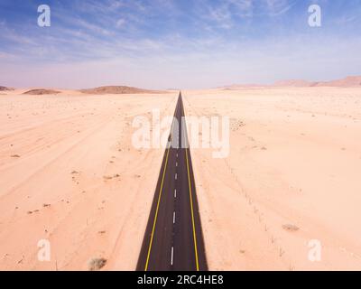Blick aus dem hohen Winkel über eine Autobahn, die sich durch die Wüste erstreckt Stockfoto