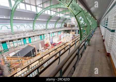 Birmingham, Großbritannien. 12. Juli 2023. Ein Swimmingpool aus dem Jahr 1907 ist die Heimat einer vorübergehenden Umwandlung in ein Wohnzimmer. Das Balsall Heath Gala Pool in der Innenstadt von Balsall Heath, Birmingham, bietet Kunstwerke, Teppiche und weiche Möbel, die einen willkommenen Ort für eine Tasse Tee und ein Gespräch bieten. Die Bäder der Moseley Road werden zur gleichen Zeit renoviert, um ihre edwardianischen Armaturen und Armaturen zu präsentieren. Kredit: Peter Lopeman/Alamy Live News Stockfoto