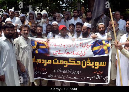 Hyderabad, Pakistan, 12. Juli 2023. Mitglieder der Eisenbahnarbeiter-Gewerkschaft halten Protestdemonstration gegen die Entweihung des Heiligen Korans in Schweden, am Mittwoch, den 12. Juli 2023, im Peshawar Presseclub. Stockfoto