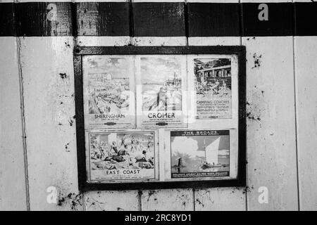 Bahnfahrplan und Reiseplakate am stillgelegten Bahnhof Honing in der Nähe des kleinen Dorfes Honing, Norfolk, sind jetzt Teil des Weaver's Way. Stockfoto