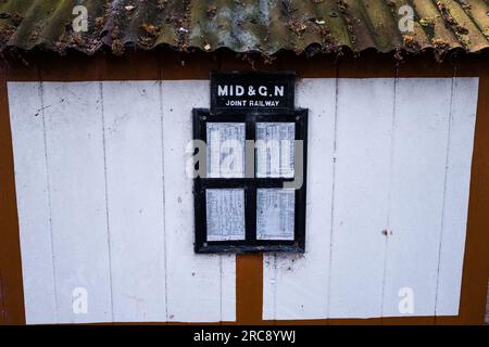 Bahnfahrplan und Reiseplakate am stillgelegten Bahnhof Honing in der Nähe des kleinen Dorfes Honing, Norfolk, sind jetzt Teil des Weaver's Way. Stockfoto