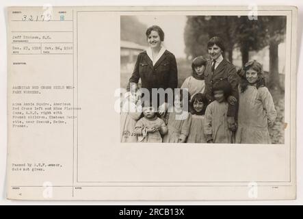 Links: Miss Annie Squire vom amerikanischen Roten Kreuz, Mitte: Französische Kinder, rechts: Miss Florence Cass vom amerikanischen Roten Kreuz. Das Foto wurde im Chateau Hachette in der Nähe von Sceaux, seine, Frankreich, aufgenommen. Das Datum wurde nicht angegeben, aber es wurde vom A.E.F.-Zensor verabschiedet. Stockfoto