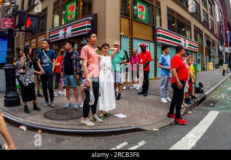 Belebte Ecke vor einem 7-Eleven-Supermarkt in Midtown Manhattan in New York am Sonntag, den 2. Juli 2023. (© Richard B. Levine) Stockfoto