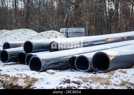 Für die Installation vorbereitete Abwasserrohre aus Kunststoff. Der Wiederaufbau des städtischen Abwassersystems Stockfoto