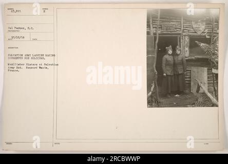 Auf diesem Foto sehen Sie Freiwillige der Heilsarmee, bekannt als „Lassies“, wie sie im Ersten Weltkrieg Donuts für Soldaten herstellen Das Foto wurde von Cel Parker am 25. Oktober 1918 in der Heilsarmee in Nonsard Woods, Frankreich, aufgenommen. Das offizielle Symbol der Heilsarmee, der Buchstabe "E", ist auf dem Bild zu sehen. Stockfoto