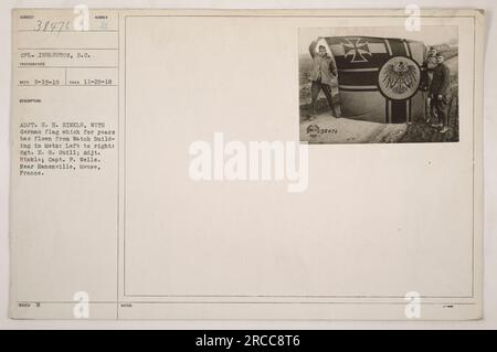 CPL. Ingleston, S.C., Fotograf, machte dieses Foto am 20. November 1918. Die Abbildung zeigt Adjt. H. H. Hinkle mit einer deutschen Flagge, die vom Wachgebäude in Metz geflogen war. Ebenfalls abgebildet sind Sergeant E. G. Guill und Captain F. Wells. Das Foto befindet sich in der Nähe von Hanenville, Mause, Frankreich. Stockfoto