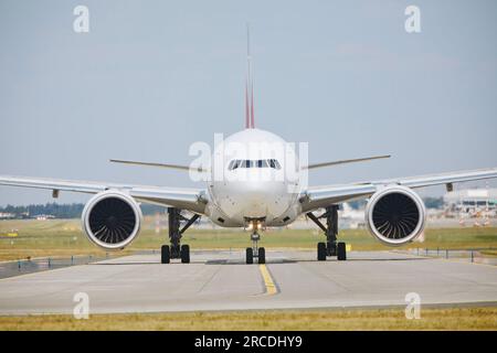 Das Flugzeug fährt während des sonnigen Sommertags zur Startbahn. Heiße Luft hinter Düsentriebwerken des Flugzeugs am Flughafen. Stockfoto