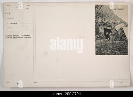 Amerikanische Soldaten decken sich hinter dem Haus eines belgischen Bauern in Lombartzyde. Dieses Foto wurde während des Ersten Weltkriegs aufgenommen, als Soldaten Schutz vor dem andauernden Konflikt suchten. Stockfoto