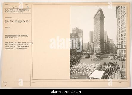 Naval Reserve Band, vorbei am Rezensionsstand am Madison Square während der Independence Day Parade in New York City. Das berühmte Flatiron Building ist im Hintergrund zu sehen. Stockfoto