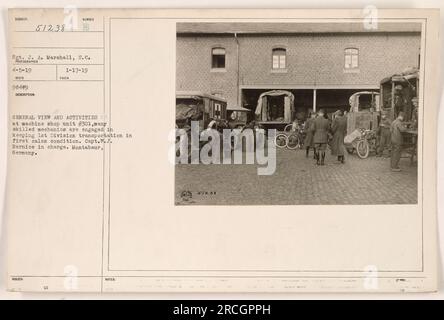 Die Abbildung zeigt Maschinenwerkstatt 301 in Montabaur, Deutschland. Erfahrene Mechaniker arbeiten unter der Leitung von Captain W. J. Barnice, um den Transport für die 1. Division aufrechtzuerhalten. Dieses Bild wurde am 5. April 1919 von Sergeant J. A. Marshall aufgenommen. Lichtbildausweis: 98479, 51238. Stockfoto