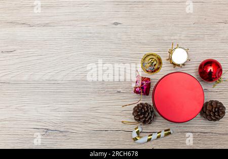 Weihnachtliche Geschenkboxen mit Blick aus dem hohen Winkel auf rustikalem Holzfußboden. Die Geschenke sind an den Rändern des Rahmens verstreut, sodass etwas Platz bleibt Stockfoto