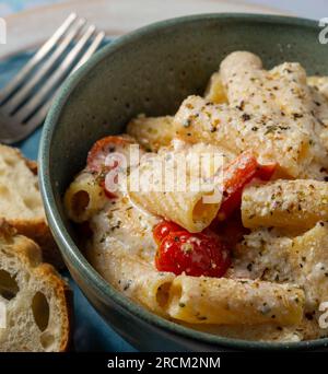 Rigatoni-Pasta mit Kirschtomaten und Ricotta-Sauce. Studioaufnahme. Stockfoto