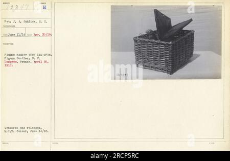 Pvt. J. A. Schlick vom Signalkorps zeigt ein Foto, das am 30. April 1918 in Langres, Frankreich, aufgenommen wurde. Das Bild zeigt einen Taubenkorb mit offenem Deckel. Es ist von der Taubensektion des Signalkorps. Das Foto wurde zensiert und am 14. Juni 1918 vom M.I.B.-Zensor veröffentlicht. Stockfoto