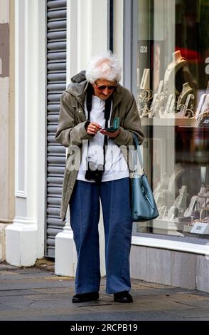 Dundee, Tayside, Schottland, Großbritannien. 16. Juli 2023. UK Weather: Juli Sonntagmorgen in Tayside, Schottland, war hell und feucht, mit Temperaturen von etwa 20 Grad Lokale Modefrauen verbringen den Tag im Stadtzentrum von Dundee und genießen das Wetter am Wochenende, während sie über ihre Mobiltelefone und iPhones kommunizieren. Kredit: Dundee Photographics/Alamy Live News Stockfoto