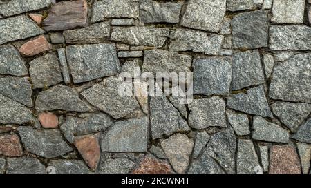 Eine Steinmauer aus Stein und Kies Stockfoto