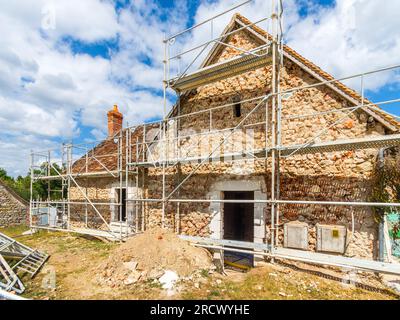 Gerüste rund um das alte Landhaus, das renoviert wird - Rosnay, Indre (36), Frankreich. Stockfoto