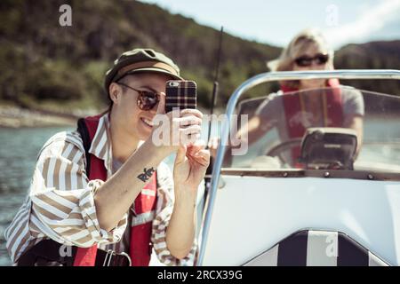 Das Mädchen nimmt sich selbst auf ein Schnellboot und lächelt Stockfoto