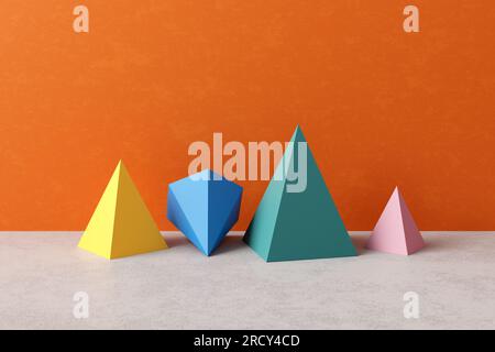 Dreidimensionale Prismenpyramidenobjekte auf blauem Hintergrund. Geometrische Figuren oder platonische Feststoffe. Unterschied, Individualität und Diversität CO Stockfoto