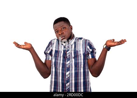 Porträt eines gut aussehenden verwirrten jungen Mannes, der seine Arme hebt und mit den Schultern zuckt. Stockfoto