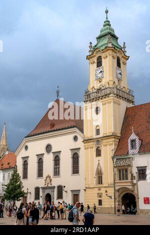 Bratislava, SK – 10. Juni 2023 Vertikale Sicht auf Touristen, die das Alte Rathaus aus aus dem 14. Jahrhundert besuchen. Das älteste Rathaus des Landes und es Stockfoto