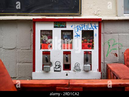 Berlin, Deutschland. 15. Juli 2023. An der Fassade eines Gebäudes in der Bülowstraße in Schöneberg hängt ein Kaugummiautomat. Obwohl die nostalgischen Verkaufsautomaten heute viel weniger beliebt sind als vor etwa 50 Jahren, haben sie immer noch eine Fangemeinde. (Zu dpa 'Alte Liebe rostet nicht - warum Kaugummi-Automaten so nostalgisch sind') Kredit: Jens Kalaene/dpa/Alamy Live News Stockfoto