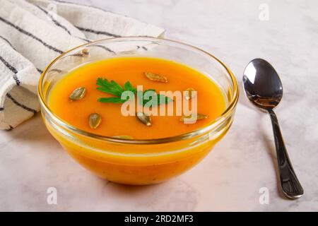 Vegetarische Herbstsuppe mit Kürbis und Süßkartoffeln auf hellem Marmorhintergrund. Stockfoto