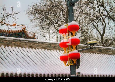 Erkunden Sie den Reiz traditioneller Laternen in einer sonnenbeleuchteten chinesischen Straße. Tauchen Sie ein in den kulturellen Charme dieser bezaubernden Umgebung. Stockfoto