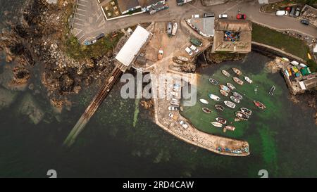 Luftlandschaft des malerischen Fischerdorfes Coverack in Cornwall mit alter Rettungsbootstation und Gezeitenhafen mit traditionellem Fi Stockfoto