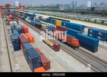 Zhengzhou, Deutschland, wartet auf Abfahrt am Bahnhof Putian in Zhengzhou. 18. Juli 2013. Dieses Luftfoto wurde am 18. Juli 2023 aufgenommen und zeigt einen Güterzug zwischen China und Europa nach Hamburg, Deutschland, der auf die Abfahrt am Bahnhof Putian in Zhengzhou wartet, der Hauptstadt der zentralchinesischen Provinz Henan. Zhengzhou hat seit dem 18. Juli 2013 7.572 Güterzüge zwischen China und Europa abgefertigt, die 670.000 TEU (20 Fuß äquivalente Einheiten) beförderten. Kredit: Li Jianan/Xinhua/Alamy Live News Stockfoto