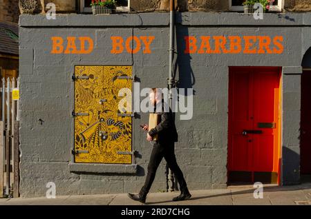 EDINBURGH, SCHOTTLAND, Großbritannien - 09. Juni 2023 - Ein Mann geht vorbei an "Bad Boy Barbers" in der Altstadt von Edinburgh, Schottland, Großbritannien - Foto: Geopix Stockfoto