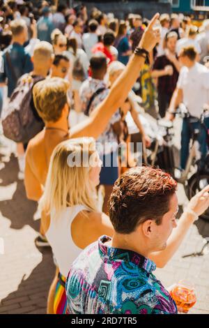 Amsterdam, Nordholland, Niederlande – 6. August 2022: Die Menschen feiern Pride Amsterdam an einem sonnigen Sommertag, der von hinten gedreht wird Stockfoto
